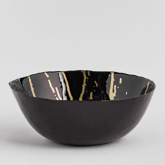 Čierna dekoračná misa so zlatými prvkami vo vnútri. 