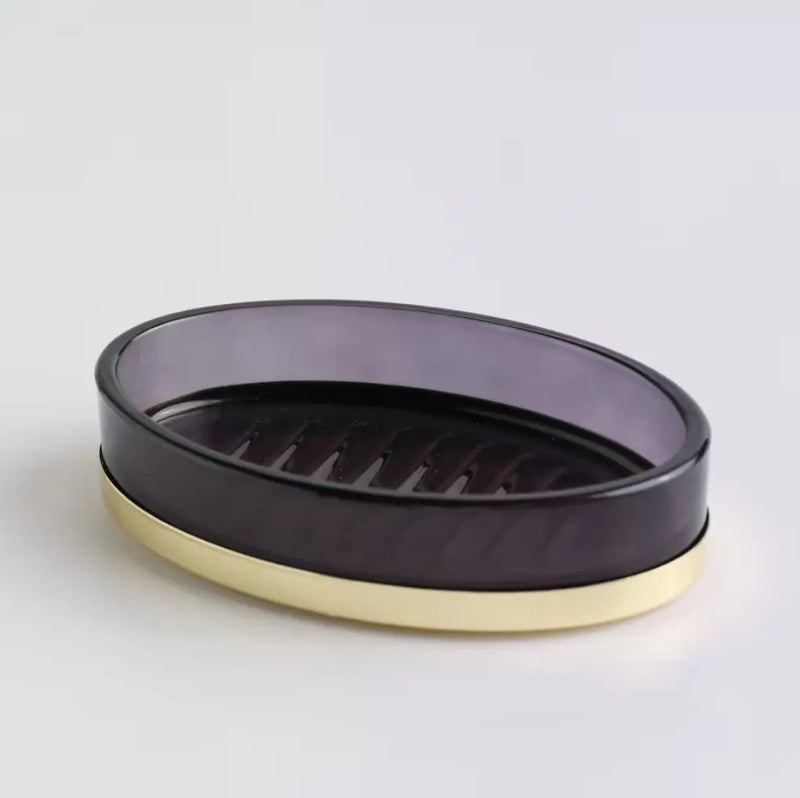 Čierna sklenená mydelnička so zlatou podstavou.