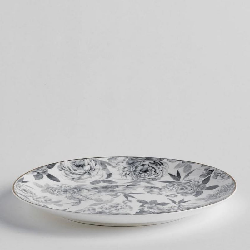 Sivý porcelánový plytký tanier s motívom sivého kvetu a zlatým okrajom. 